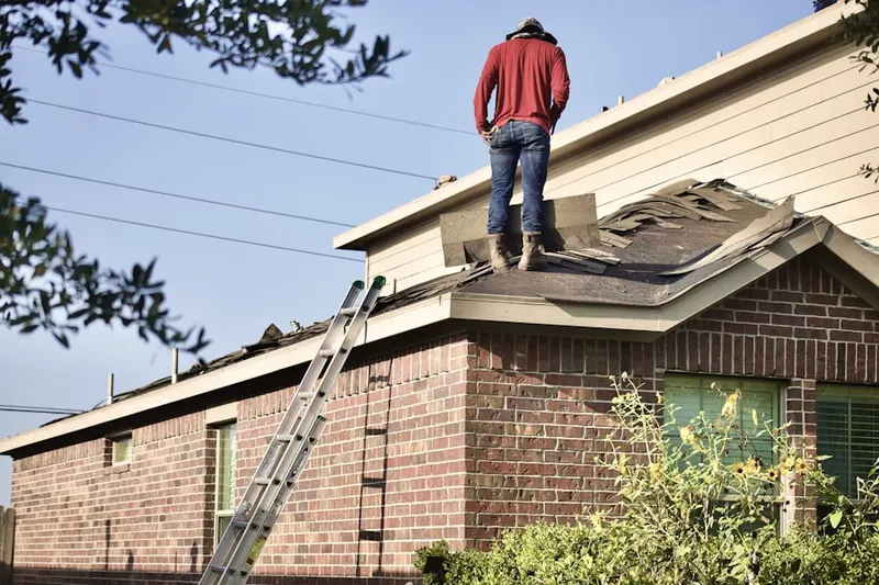 Professional roofer working on a residential roof in Patuxent